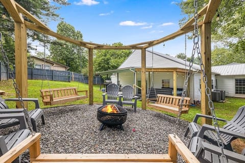 Catch up with friends and family at the serene outdoor wood burning fireplace with a custom built pergola and swings!
