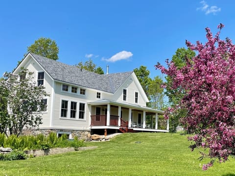 Exterior view of South porch and lawn in Springtime.