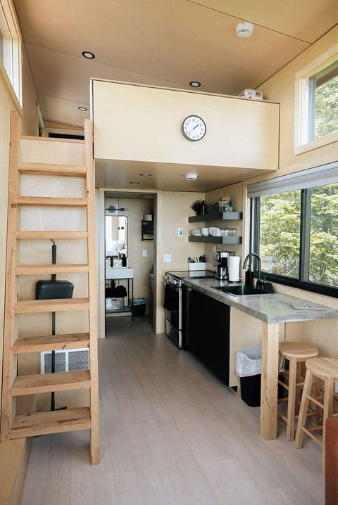 Living space with custom kitchen, full bath, loft, and loveseat