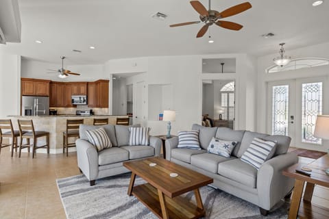 Queen sleeper sofa looking towards kitchen.  65 inch TV at camera