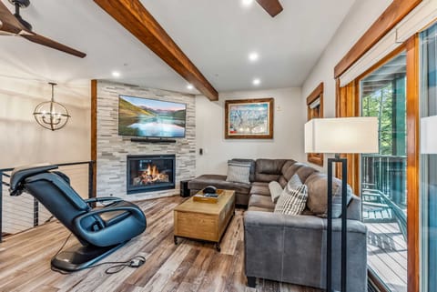 Living Room: Large sectional couch w/pull out bed, massage chair, 57” TV, soundbar, fireplace, access to balcony, ample natural light
