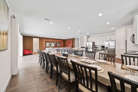 - Long dining table for family meals and gatherings
- Orlando vacation rental with open kitchen space
- Spacious home designed for group dining needs