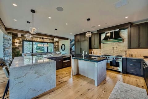 Cook in style in this gourmet kitchen featuring high-end appliances, sleek countertops, and plenty of space for preparing meals while enjoying beautiful mountain views