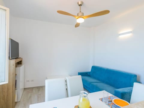 Table, Property, Couch, Ceiling Fan, Orange, Lighting, Interior Design, Yellow, Wood, Comfort