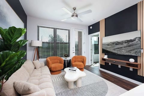 Relax in our cozy living room, where comfy sofas, large windows, and vibrant greenery create a serene ambiance.