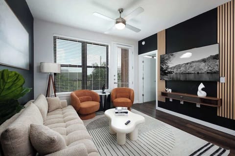 Enjoy the perfect blend of comfort and style with cozy sofas, a TV, and an eye-catching painting in our living room.