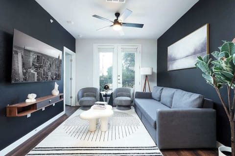 Our living room is the perfect retreat, with comfy seating, a large window, and artistic touches that add personality.