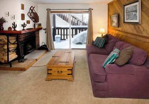 Living room w TV and balcony access