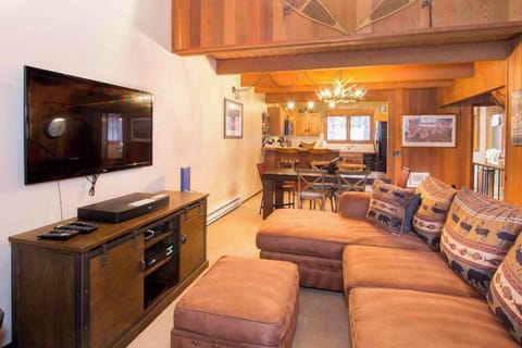 Living room w/ DVD player, Youtube TV (and Amazon Firesticks), wood burning fireplace and balcony access w/ BBQ grill
