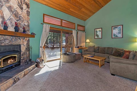 Living room w/ 40" flat screen TV, DVD player, board games, wood burning fireplace