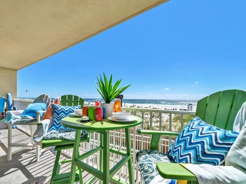 Your private oceanfront balcony awaits with vibrant seating and coastal breezes for morning coffee or sunset cocktails.