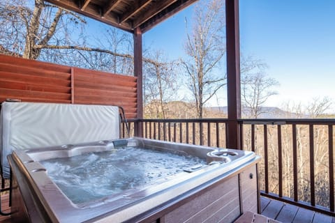 Soak away your stress in your private hot tub while taking in stunning mountain views from this peaceful covered deck.