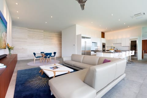 Luxuriously spacious media room flows into a modern kitchen, perfect for social gatherings.