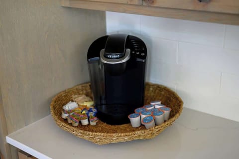 Keurig coffee station with assorted pods and creamers, ready to start your morning in comfort and style.