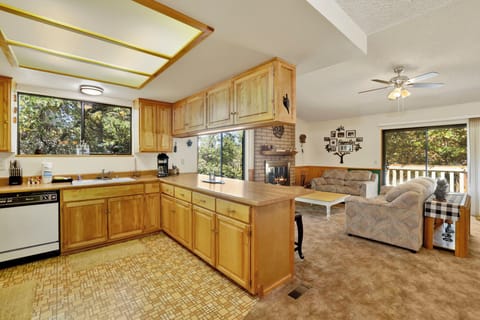 Fully equipped cabin kitchen with ample cabinetry, stove, fridge, microwave, and coffee maker—perfect for cooking meals, morning coffee, and feeling right at home on your stay.