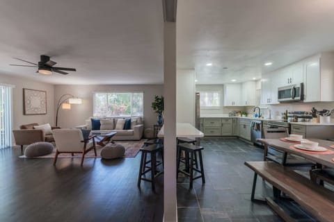 The living room and kitchen are open with a bar/window.