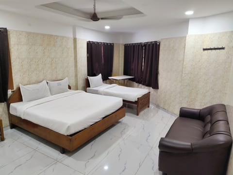 Deluxe Triple Room | Desk, blackout drapes, iron/ironing board, bed sheets