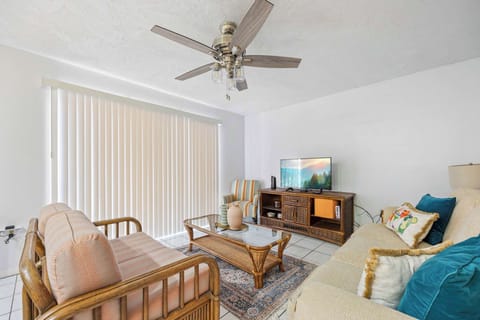 Relax in the cozy living room with natural light and comfortable seating.