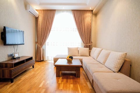 Family Apartment, Balcony, Courtyard View | Living area | Flat-screen TV