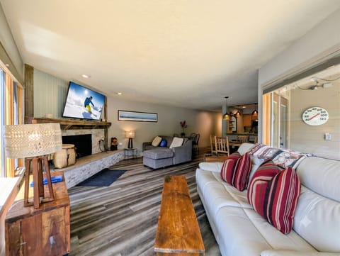 Sink into plush sofas by the stone fireplace, gather around the open kitchen, and unwind in this inviting space designed for relaxation and togetherness after mountain adventures.