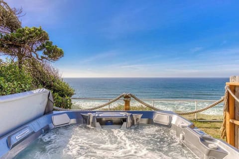 Picture yourself unwinding in this bubbly hot tub with breathtaking ocean views! Pure relaxation awaits.