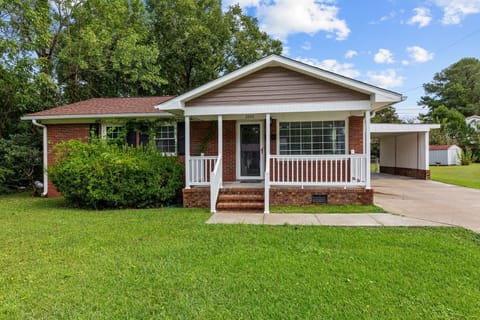Charming brick bungalow with a cozy front porch.