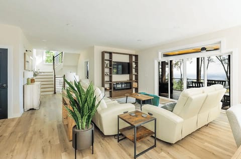 Spacious living room with comfortable seating, fireplace, and Smart TV.