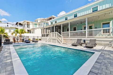 Dive into your own private oasis where crystal-clear waters meet coastal charm, complete with loungers for soaking up the Florida sunshine.