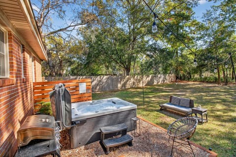 Slip into the private hot tub and soak beneath the trees — your peaceful backyard escape awaits.