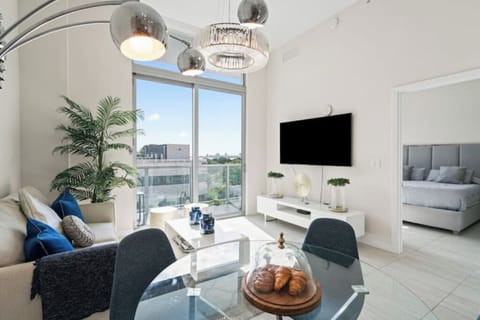Bright and spacious living room with large windows and modern furniture.