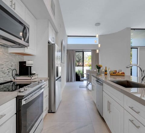 New chef's kitchen w/ island seating up to 6. Full frig, microwave, oven/stove.