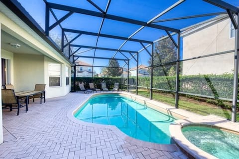 Screened-in backyard patio featuring a swimming pool and an attached hot tub.