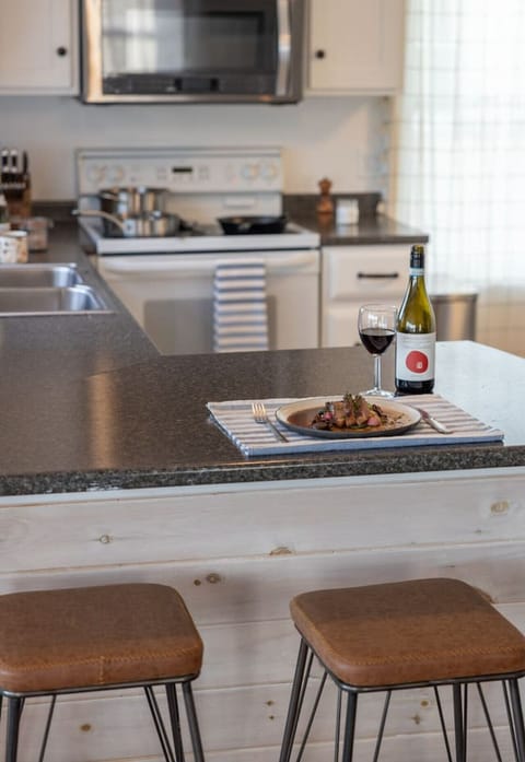The fully stocked kitchen opens up to the living/dining area.