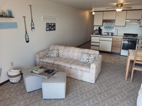 LIVING ROOM: Very comfy living room with a sofa bed, comfy chairs, ottomans, streaming television, and wall A/C unit.