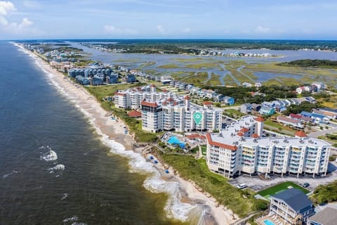 Breathtaking aerial view showcasing the pristine coastline of Topsail Beach, NC. The perfect spot for those looking to enjoy serene ocean views and peaceful beach living.