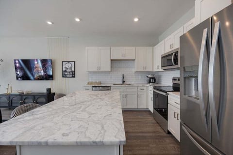 Full kitchen with stainless steel appliances and breakfast bar with seating for 2