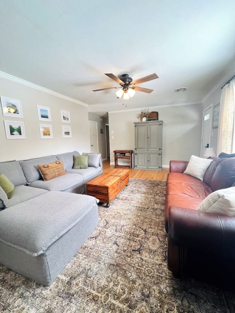 Main level living space with sectional, leather sofa, games, and smart TV