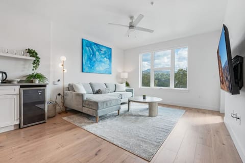 Beautifully designed living room. 65` TV, comfy sofa and amazing views of mountains and city skyline.