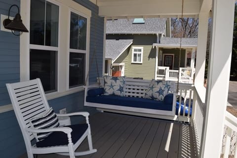 Porch swing with pool across the street