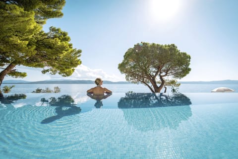 Seasonal outdoor pool, open 9:00 AM to 8:00 PM, pool umbrellas