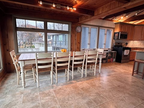 Dinning table has 6 chairs and a bench along the wall