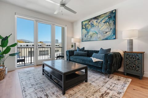 Beautifully designed living room. 75` TV, comfy sofa and amazing views of mountains and city skyline.