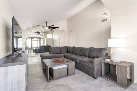 Living room with large sectional sleeper sofa & 65" Smart TV w/ HULU