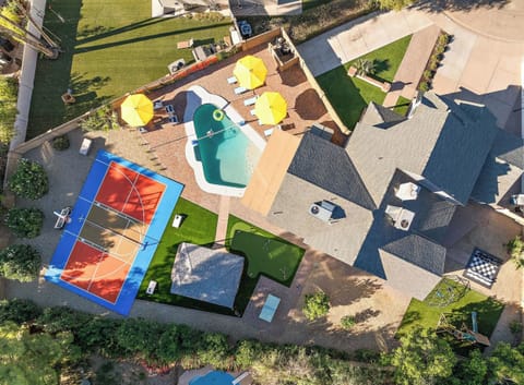 Experience the beauty from above! Our spacious backyard features all the fun you could dream of.