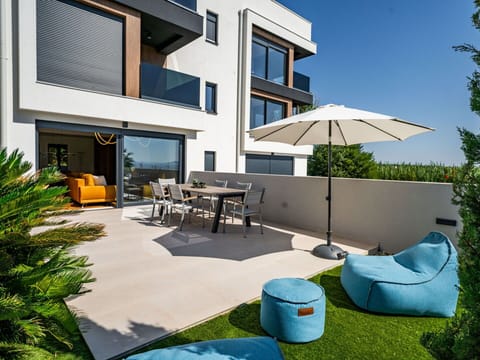 Building, Plant, Property, Furniture, Sky, Green, Window, Shade, Outdoor Furniture, Chair