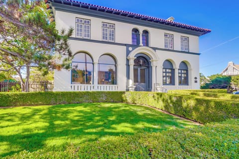 Elegant Mediterranean-style villa with manicured gardens and classic architectural details in a peaceful neighborhood setting.