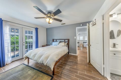 Bright queen bedroom with abundant natural light and a peaceful setting for extended stays.