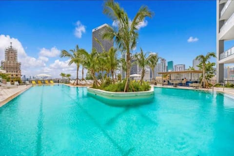 Unwind at our cozy pool with breathtaking city views.