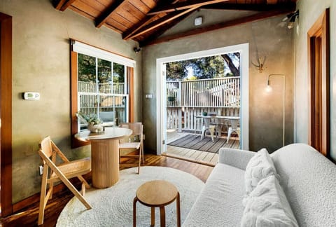 This inviting living and kitchen space opens up to a tranquil private patio for a perfect retreat.