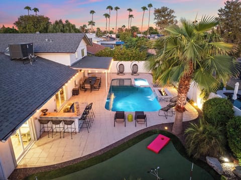 Illuminate your evenings! This aerial shot captures the beauty of our backyard under the night sky.